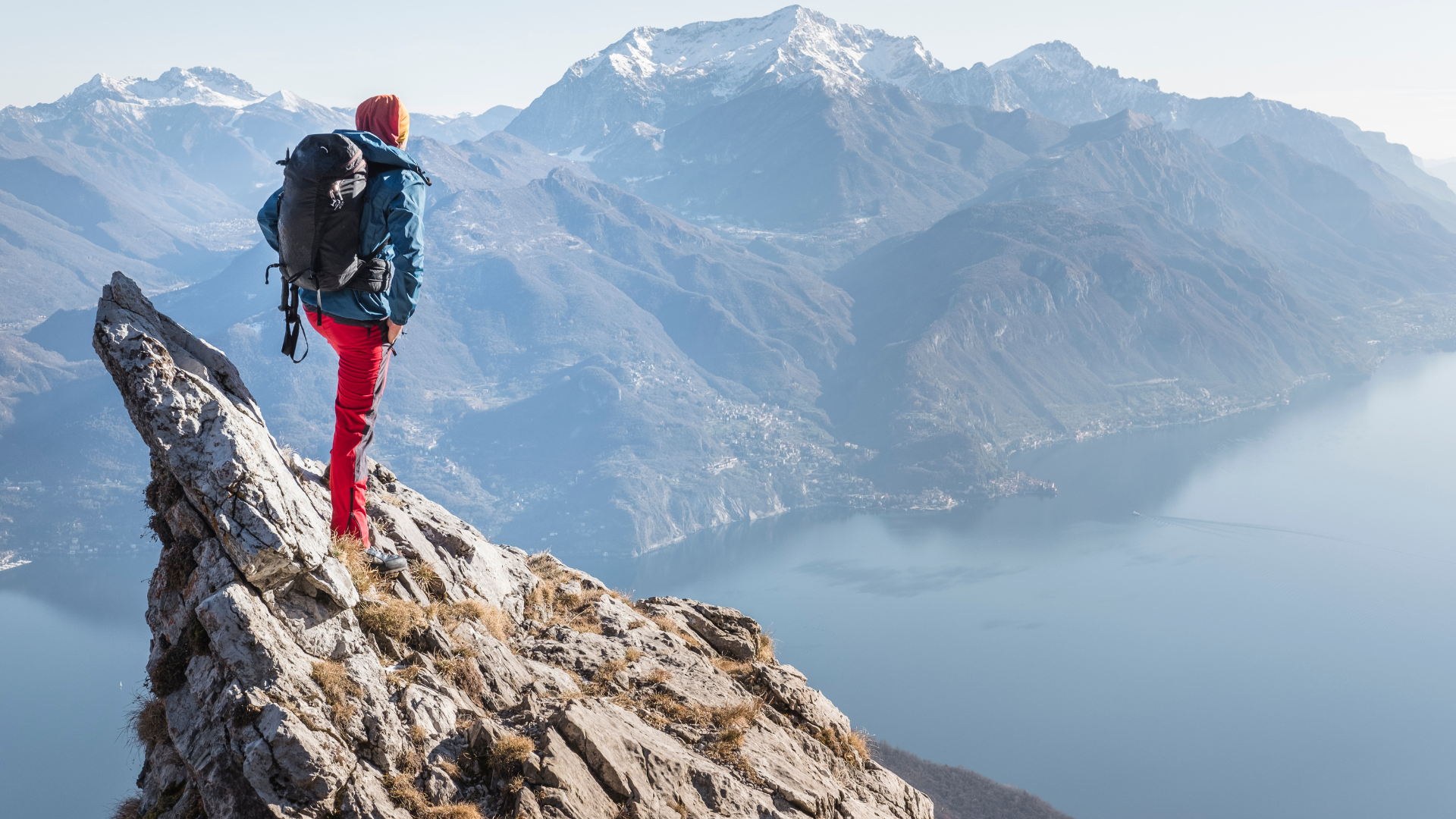 A climber standing on a summit, arms raised — the founder who reached the top of the climb